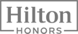 The image displays the logo for Hilton Honors, featuring the word "Hilton" above "HONORS" within a rectangular outline.