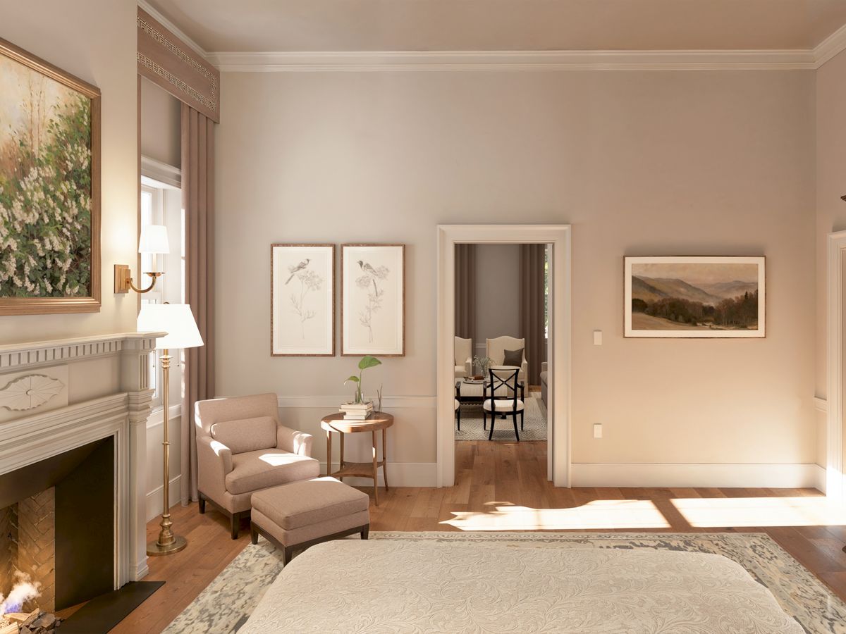 A cozy hotel room with a lit fireplace, beige walls, a seating area, art frames, and a doorway leading to another room, all bathed in natural light.